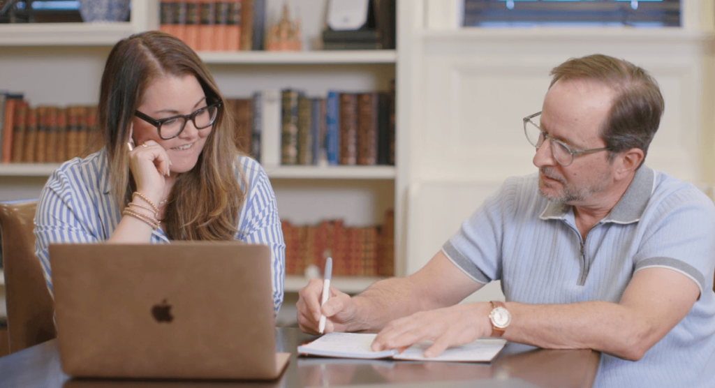 Two people collaborating on a document at a desk